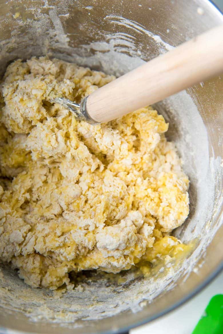 Mixing in the dry ingredients to make brioche dough in a bowl.