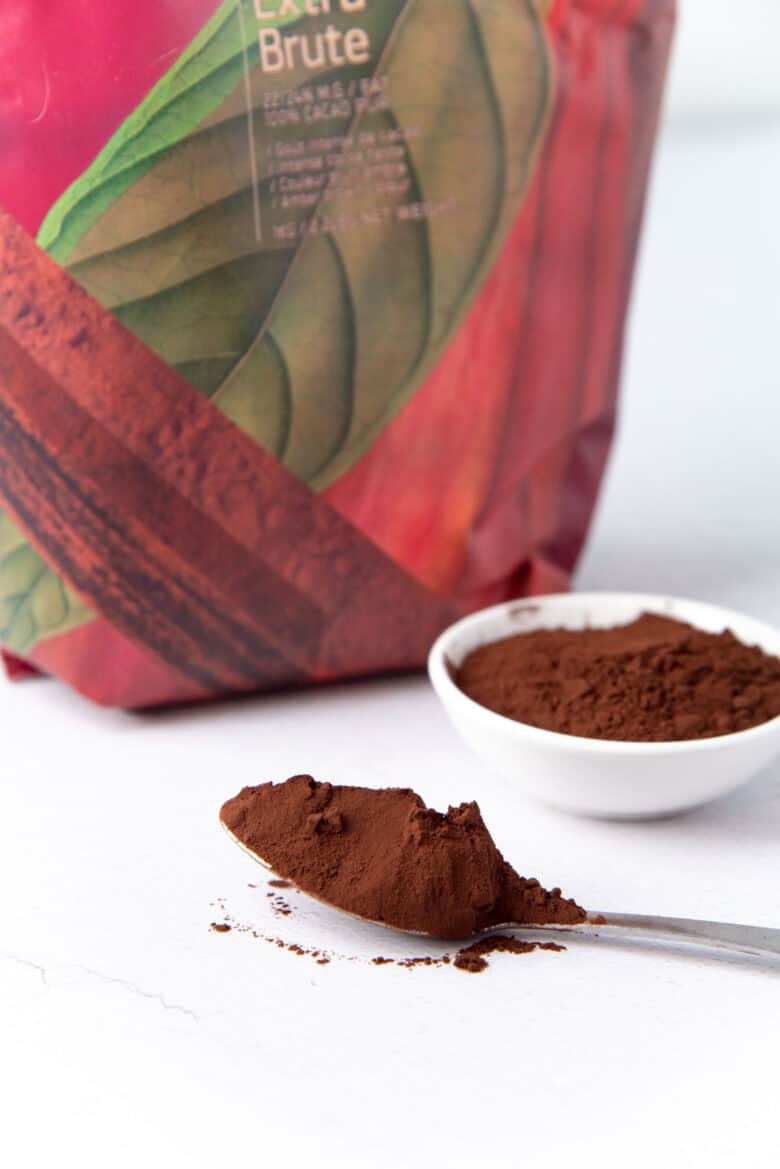 A close up of dutch process cocoa powder on a spoon.