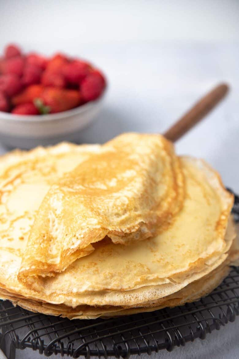 A stack of french crepes on a wire rack
