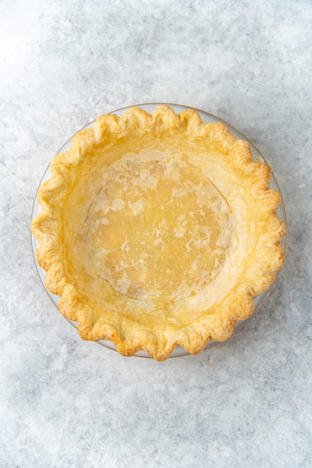 A par baked crust, ready to be filled and baked.