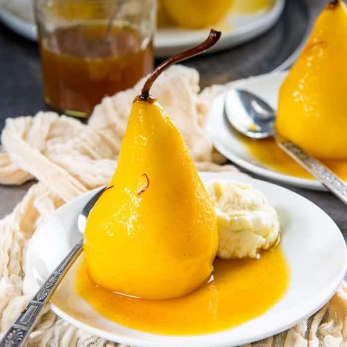 Saffron Poached Pears - a delicious and simple dessert that looks impressive! Saffron and cardamom makes this dessert luxurious and exotic, with a little spicy kick. Perfect dessert for a dinner party. 