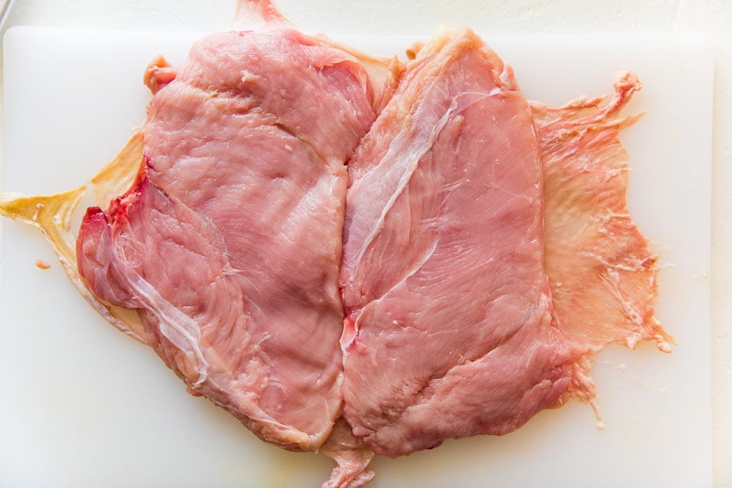 Step 6 - Place both pieces of turkey breast on the turkey skin,